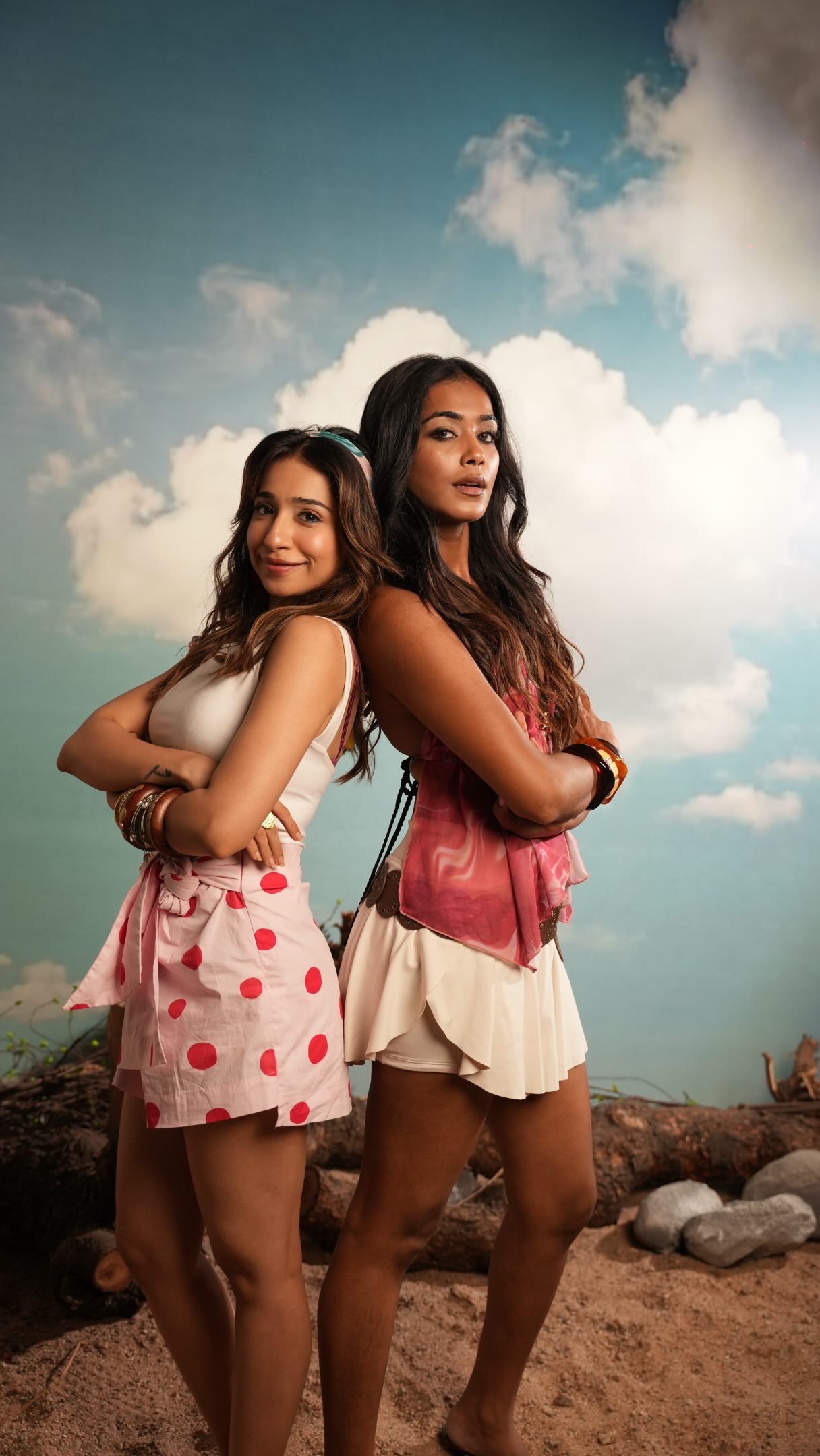 Two models photographed back to back against a painted sky backdrop on a Wabi Sabi Studio campaign shoot